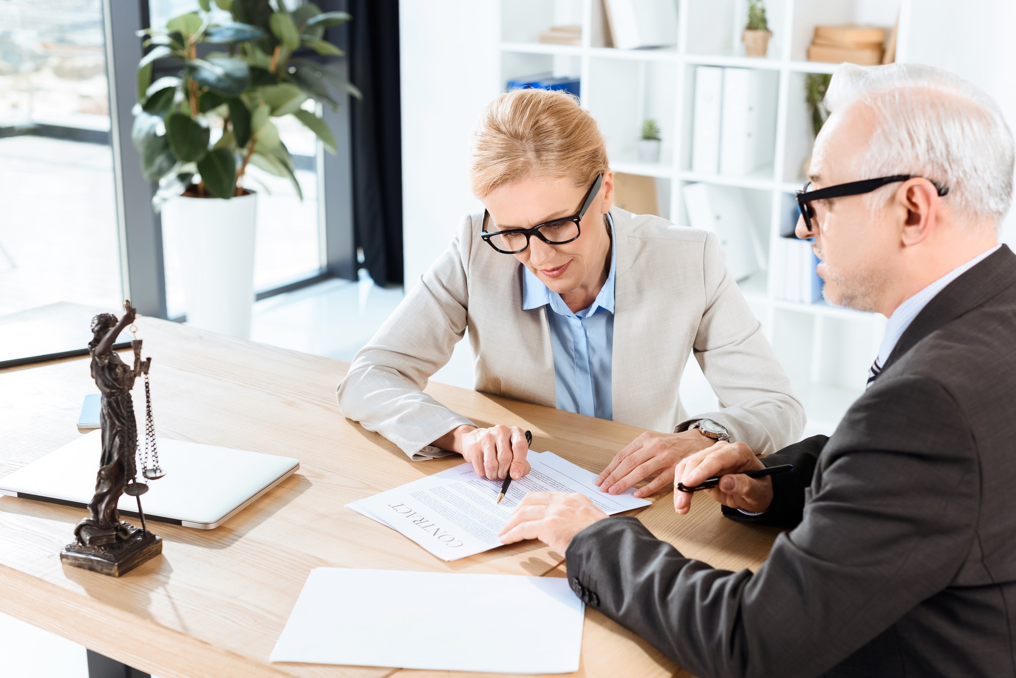 mature-lawyers-looking-at-contract-in-modern-workplace-1.jpg